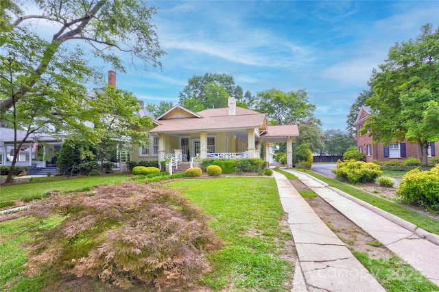 156 Union St N, Concord, NC 28025 - view of front of property with a porch, a front yard, a chimney, and driveway