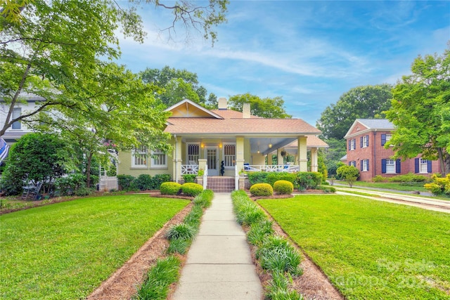 156 Union St N, Concord, NC 28025 - view of front of house with a porch, a front yard, and a chimney