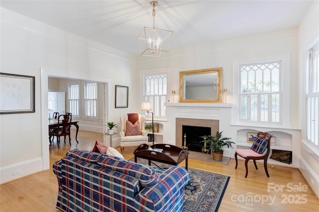 156 Union St N, Concord, NC 28025 - living area with a chandelier, healthy amount of natural light, wood finished floors, and a fireplace with flush hearth