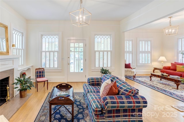 156 Union St N, Concord, NC 28025 - living area featuring a chandelier, wood finished floors, and a premium fireplace