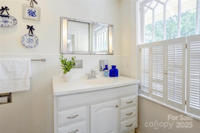 156 Union St N, Concord, NC 28025 - bathroom with plenty of natural light, vanity, tile walls, and wainscoting