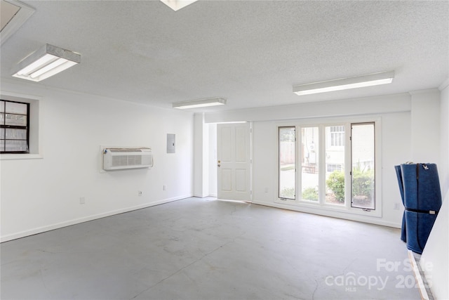 156 Union St N, Concord, NC 28025 - unfurnished room with concrete flooring, a wall unit AC, a textured ceiling, electric panel, and attic access