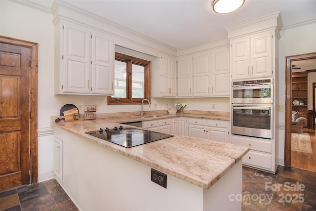 1482 Willow Oaks Trl, Matthews, NC 28104 - kitchen featuring black electric stovetop, double oven, dark stone finish flooring, a peninsula, and white cabinets