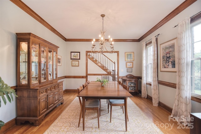 1482 Willow Oaks Trl, Matthews, NC 28104 - dining space featuring a chandelier, light wood-type flooring, and ornamental molding
