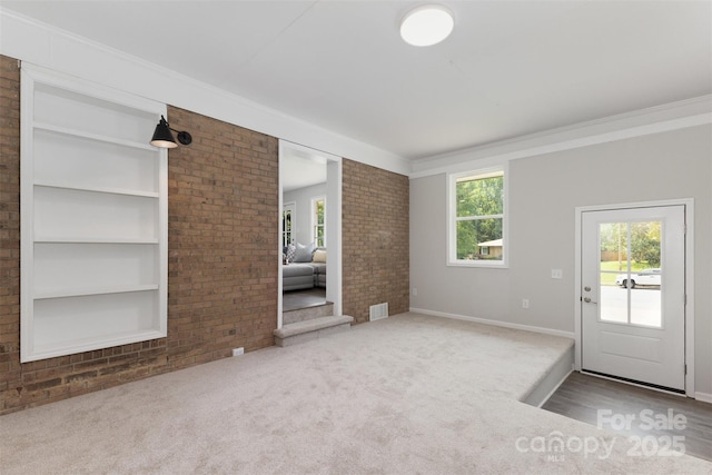 1948 Marett Blvd, Rock Hill, SC 29732 - unfurnished living room with brick wall, carpet, ornamental molding, and built in shelves