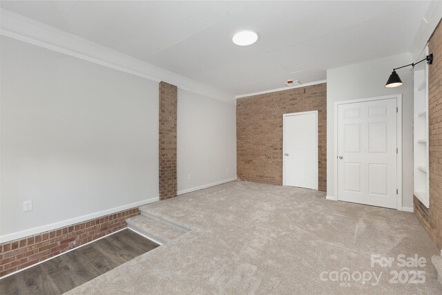 1948 Marett Blvd, Rock Hill, SC 29732 - unfurnished room featuring brick wall, crown molding, and carpet