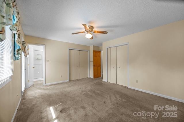 840 Deer Lake Run, Salisbury, NC 28146 - unfurnished bedroom with two closets, carpet, a textured ceiling, and ceiling fan