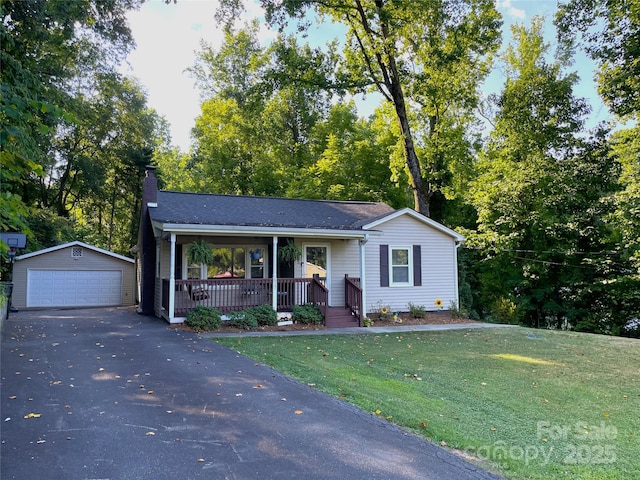 517 Stowe Dr, Lowell, NC 28098 - view of front of home with covered porch, an outbuilding, a detached garage, a chimney, and a front lawn