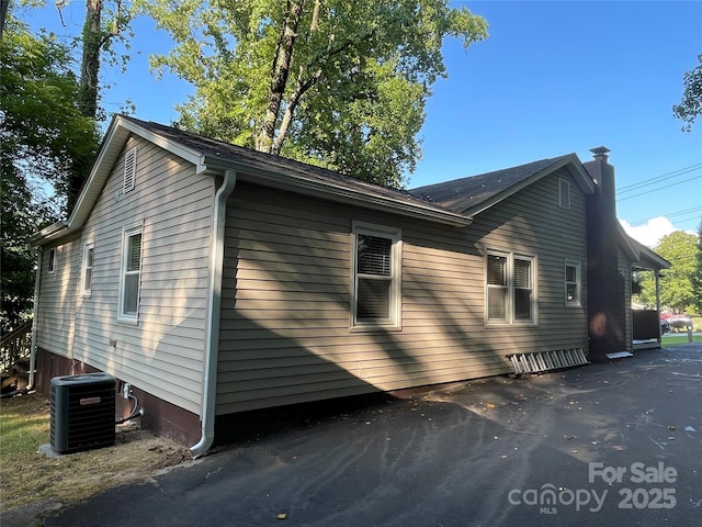 517 Stowe Dr, Lowell, NC 28098 - view of side of property featuring a cooling unit and a chimney