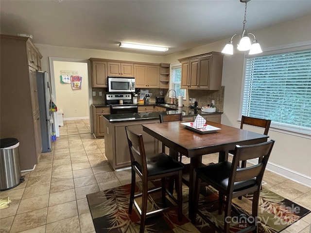 517 Stowe Dr, Lowell, NC 28098 - kitchen featuring stainless steel appliances, dark countertops, decorative backsplash, and open shelves