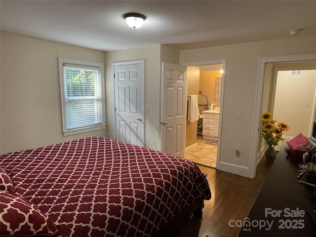 517 Stowe Dr, Lowell, NC 28098 - bedroom featuring wood finished floors, ensuite bathroom, and a closet