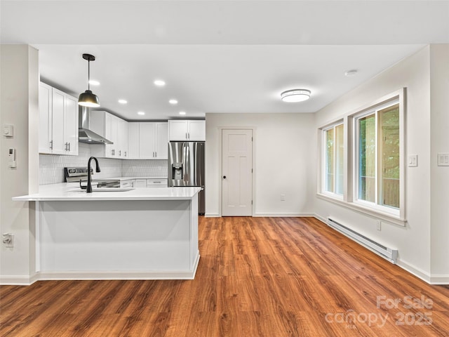1065 Oak Ridge Ln, Mars Hill, NC 28754 - kitchen featuring a baseboard radiator, stainless steel refrigerator with ice dispenser, wood finished floors, a peninsula, and light countertops