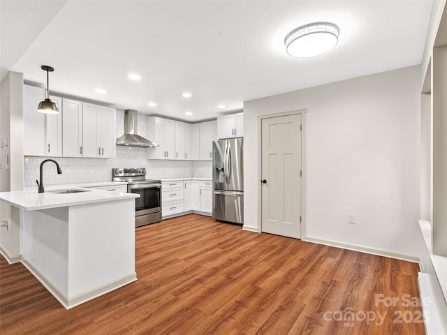 1065 Oak Ridge Ln, Mars Hill, NC 28754 - kitchen featuring appliances with stainless steel finishes, wall chimney range hood, backsplash, a peninsula, and wood finished floors