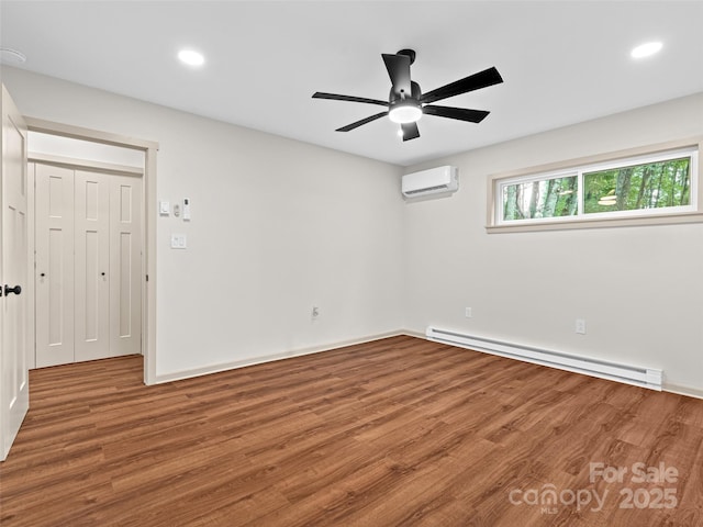 1065 Oak Ridge Ln, Mars Hill, NC 28754 - unfurnished room with a baseboard radiator, a wall mounted air conditioner, wood finished floors, a ceiling fan, and recessed lighting