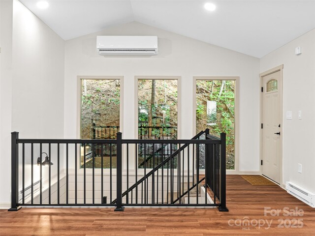 1065 Oak Ridge Ln, Mars Hill, NC 28754 - interior space featuring an AC wall unit, wood finished floors, vaulted ceiling, a baseboard heating unit, and recessed lighting