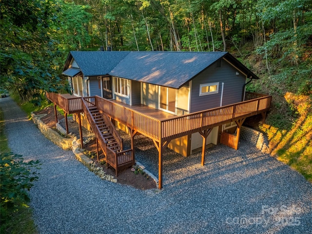 1065 Oak Ridge Ln, Mars Hill, NC 28754 - view of front of house with roof with shingles, driveway, a view of trees, and a wooden deck