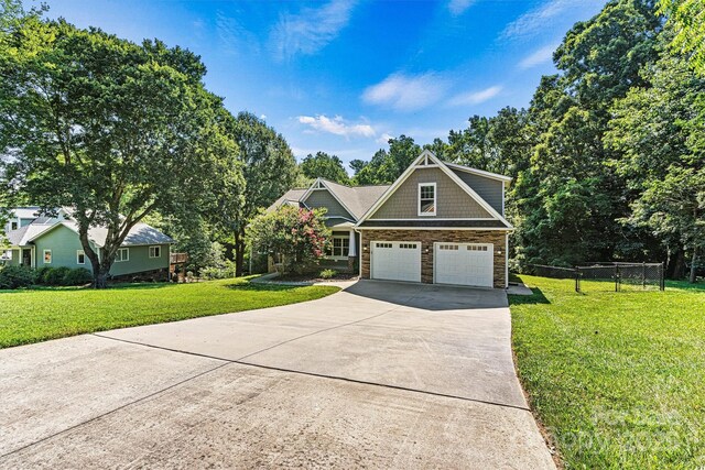 3450 4th Street Blvd NW, Hickory, NC 28601 - view of front of house with stone siding, driveway, a front lawn, and a garage