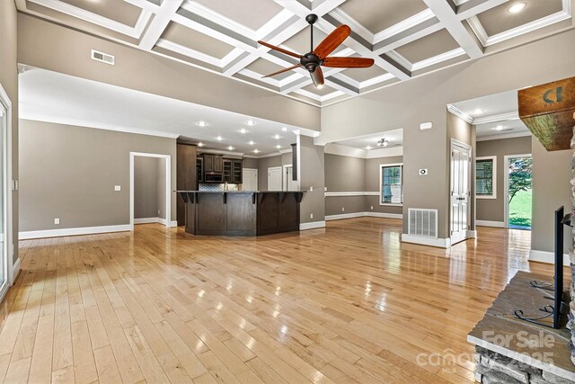 3450 4th Street Blvd NW, Hickory, NC 28601 - unfurnished living room with a towering ceiling, ceiling fan, crown molding, coffered ceiling, and light wood-type flooring