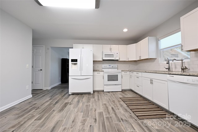 418 Stokes Ave, Clover, SC 29710 - kitchen with white appliances, light wood finished floors, tasteful backsplash, white cabinets, and recessed lighting