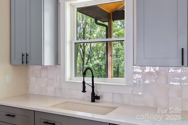 939 Rocky Mountain Rd, Lake Toxaway, NC 28747 - kitchen with gray cabinetry, tasteful backsplash, and plenty of natural light