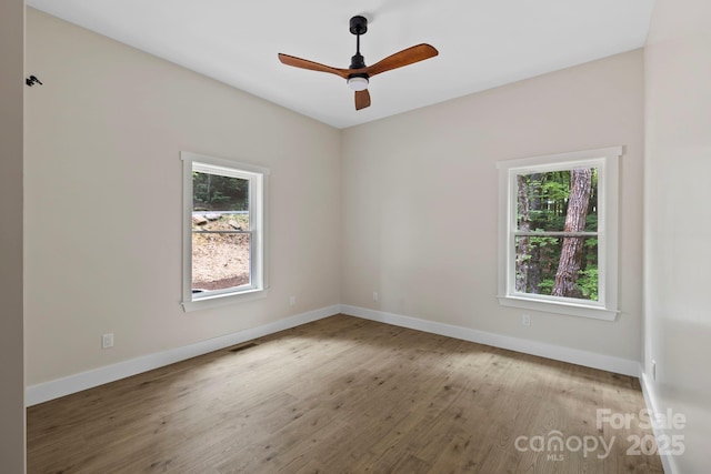 939 Rocky Mountain Rd, Lake Toxaway, NC 28747 - spare room with plenty of natural light, wood finished floors, and ceiling fan