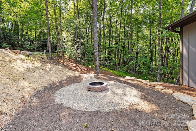 939 Rocky Mountain Rd, Lake Toxaway, NC 28747 - view of yard with a fire pit and a view of trees