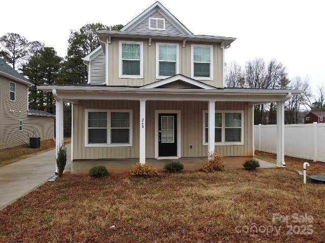 248 Mills Ave, Troutman, NC 28166 - view of front facade with covered porch and board and batten siding