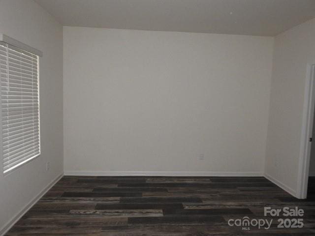 248 Mills Ave, Troutman, NC 28166 - spare room featuring dark wood-style floors and baseboards