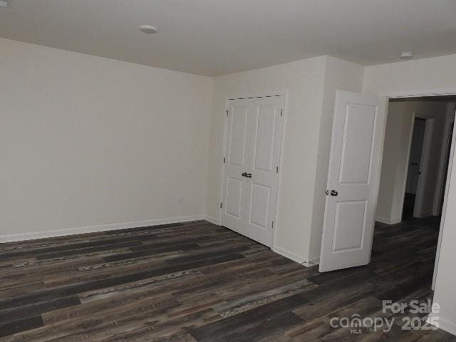 248 Mills Ave, Troutman, NC 28166 - unfurnished bedroom featuring dark wood finished floors and a closet
