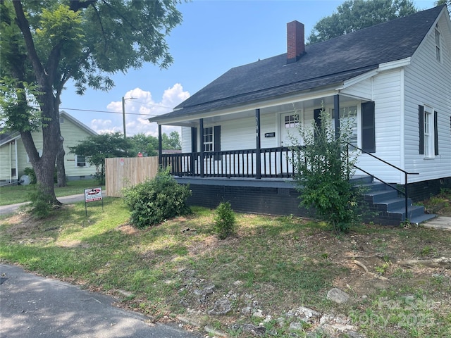 518 W White St, Chester, SC 29706 - view of front of property featuring covered porch, a chimney, and a shingled roof