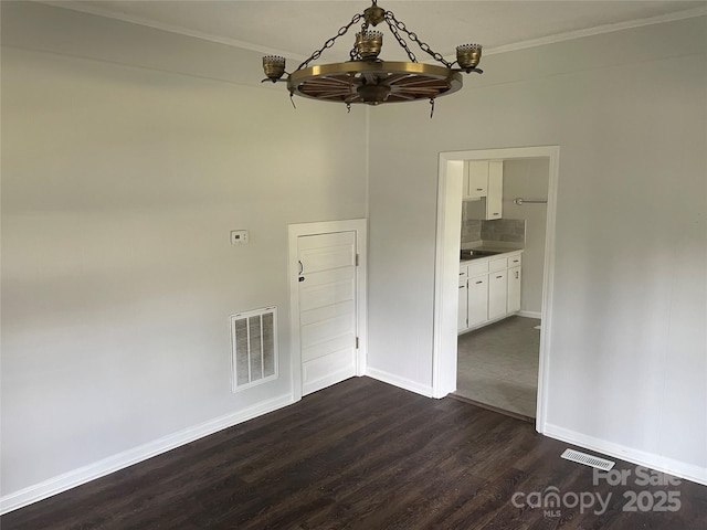 518 W White St, Chester, SC 29706 - empty room featuring a chandelier, dark wood-style floors, and ornamental molding