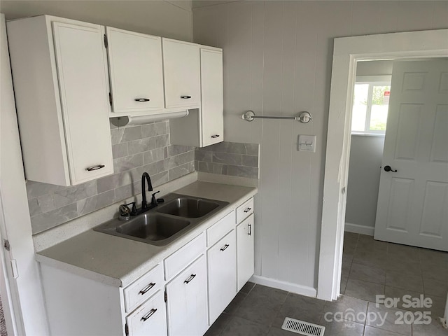 518 W White St, Chester, SC 29706 - kitchen with light countertops, white cabinetry, tasteful backsplash, and dark tile patterned floors