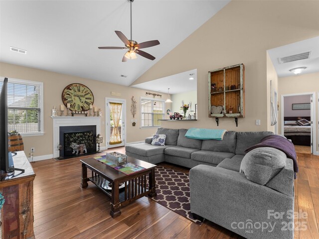 144 Haw River Rd, Fletcher, NC 28732 - living room featuring a ceiling fan, wood finished floors, a fireplace with flush hearth, and high vaulted ceiling
