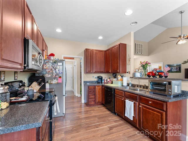 144 Haw River Rd, Fletcher, NC 28732 - kitchen with black appliances, a peninsula, light wood finished floors, dark countertops, and lofted ceiling