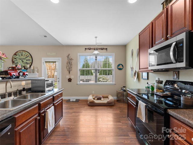 144 Haw River Rd, Fletcher, NC 28732 - kitchen featuring stainless steel microwave, black range with electric cooktop, dishwasher, dark wood finished floors, and dark countertops