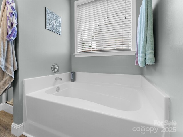 144 Haw River Rd, Fletcher, NC 28732 - bathroom with a garden tub and wood finished floors