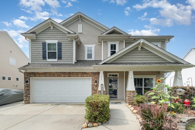 217 Fielding St, Mount Holly, NC 28120 - craftsman inspired home featuring concrete driveway, a garage, a porch, stone siding, and a shingled roof