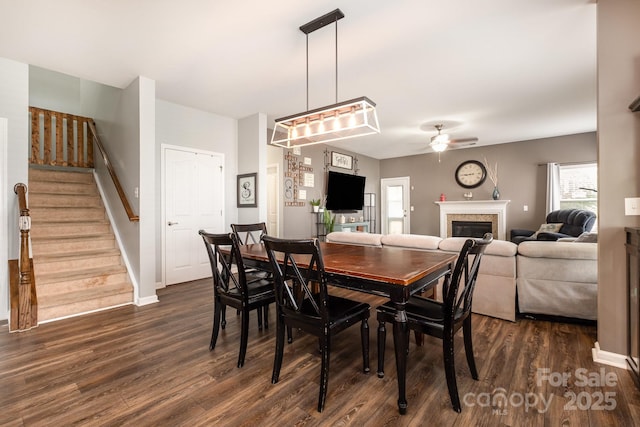 217 Fielding St, Mount Holly, NC 28120 - dining space featuring a ceiling fan, dark wood-style floors, stairway, and a fireplace