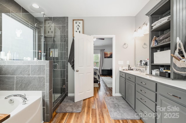 217 Fielding St, Mount Holly, NC 28120 - full bathroom with ensuite bath, wood finished floors, a bath, a stall shower, and vanity