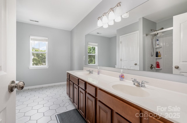 217 Fielding St, Mount Holly, NC 28120 - bathroom with double vanity, a tile shower, and tile patterned floors