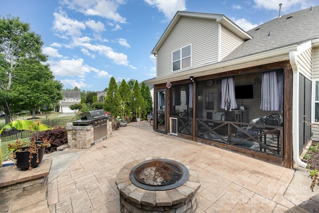 217 Fielding St, Mount Holly, NC 28120 - view of patio featuring an outdoor fire pit, exterior kitchen, and a sunroom