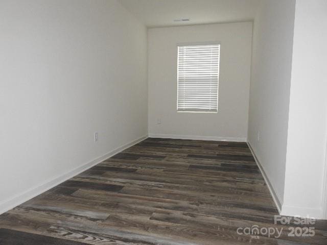 252 Mills Ave, Troutman, NC 28166 - spare room featuring dark wood-type flooring and baseboards