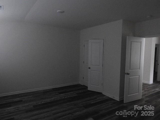 252 Mills Ave, Troutman, NC 28166 - unfurnished bedroom featuring dark wood-type flooring and baseboards