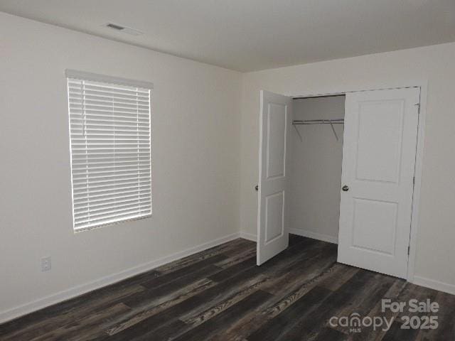252 Mills Ave, Troutman, NC 28166 - unfurnished bedroom featuring dark wood-style floors and a closet