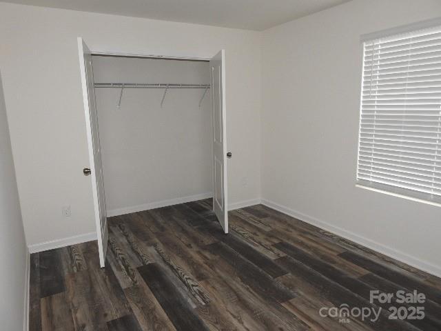 252 Mills Ave, Troutman, NC 28166 - unfurnished bedroom featuring wood finished floors and a closet