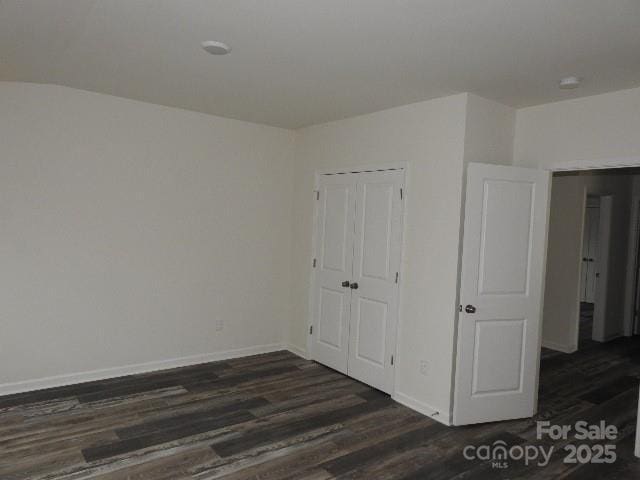 260 Mills Ave, Troutman, NC 28166 - unfurnished bedroom with dark wood-style flooring and a closet