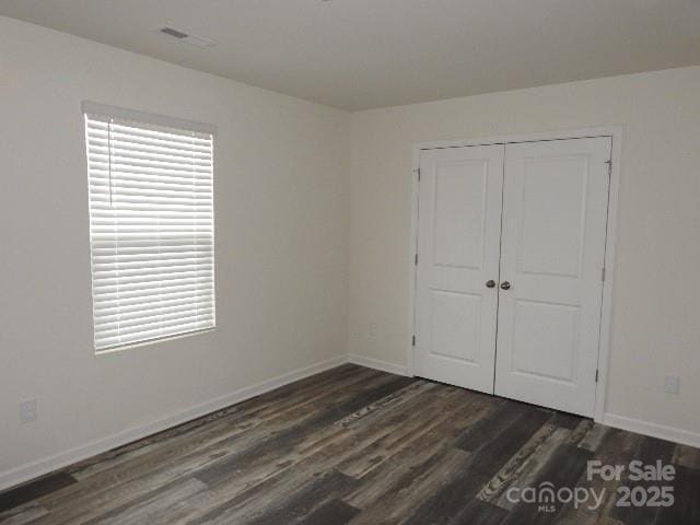 260 Mills Ave, Troutman, NC 28166 - unfurnished bedroom with dark wood finished floors and a closet