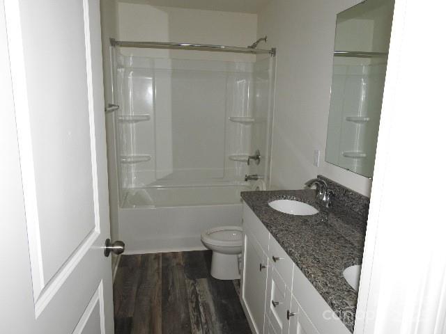 260 Mills Ave, Troutman, NC 28166 - full bathroom with double vanity, wood finished floors, and shower / washtub combination