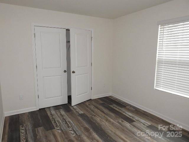 260 Mills Ave, Troutman, NC 28166 - unfurnished bedroom with wood finished floors and a closet