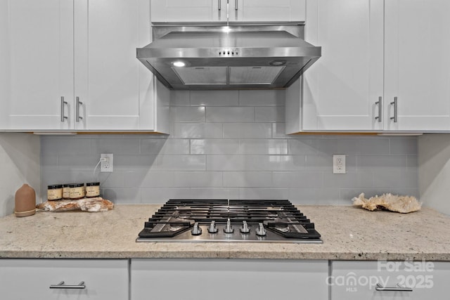 9021 Myrna Dr, Gastonia, NC 28056 - kitchen featuring range hood, stainless steel gas stovetop, white cabinetry, and decorative backsplash